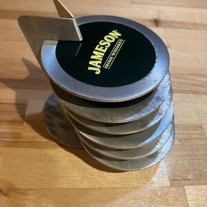 Six metal Jameson coasters, great condition, come with small rack
